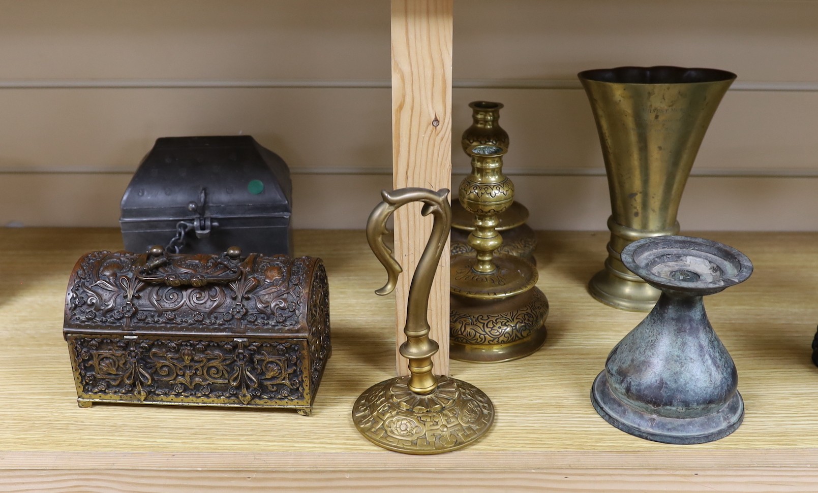 A Continental gilt brass casket, a pair of brass candlesticks, a pewter casket, another candlestick, a vase and a JVB hook (6)